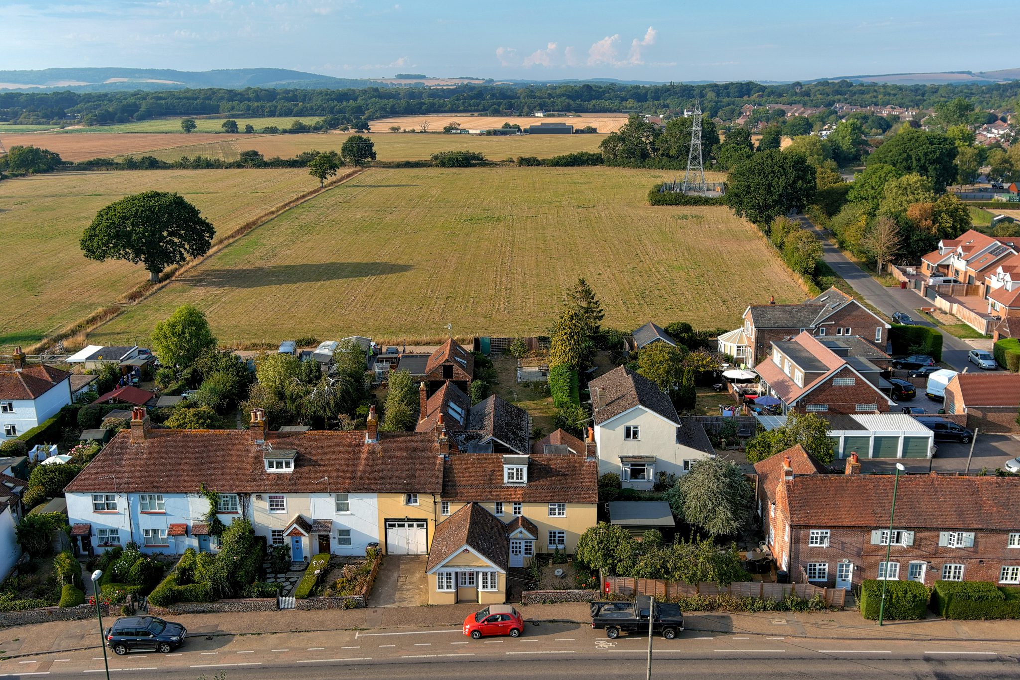 Aerial property photography showing village homes and nearby fields